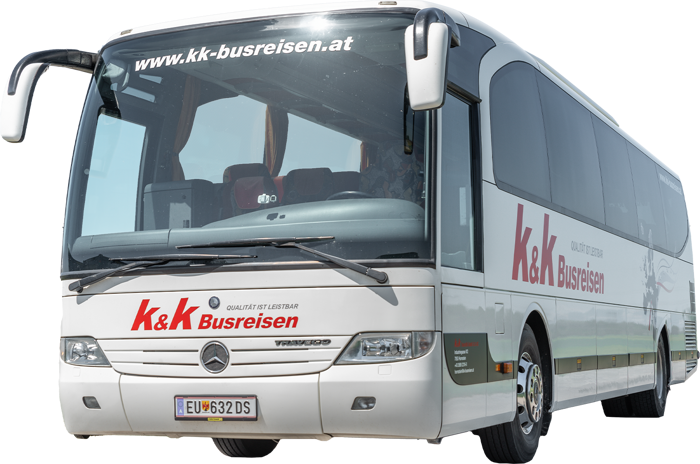 Ein weißer K&K Busreisen Reisebus mit Mercedes-Benz Logo, geparkt an einem klaren Tag.